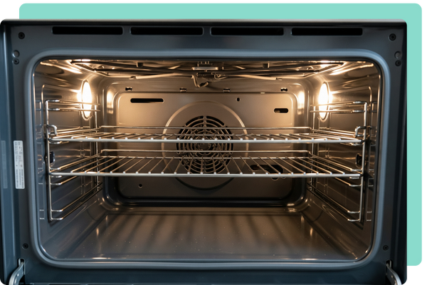 The sparkling clean interior of a modern oven, with gleaming racks free of all grime, showcasing our deep cleaning of often overlooked appliances.