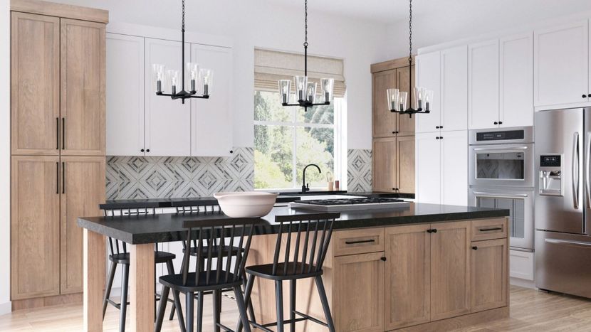 Three black chandelier pendants over a large kitchen island. Three black chandelier pendants over a large kitchen island.