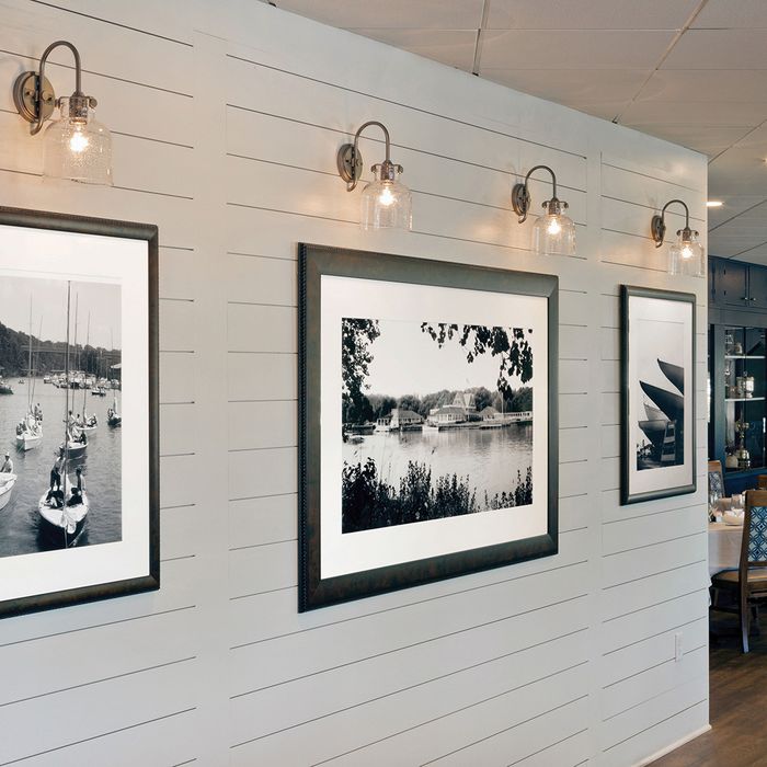 Hinkley light fixtures over portraits in a restaurant