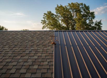 A roof featuring a contrast of brown asphalt shingles and dark metal panels, with a small scale of justice centered at their junction. Asphalt Shingle and Metal Roof with Scale of Justice