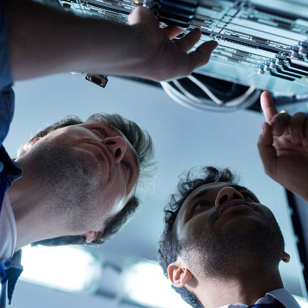 Technicians looking at the network server and detecting problems.