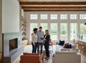 Real Estate Agent Discussing Property with Couple in Modern Home