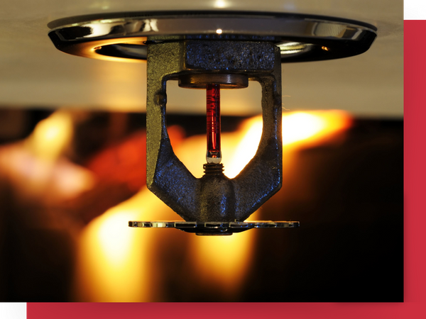 Ceiling sprinkler with flame in the background