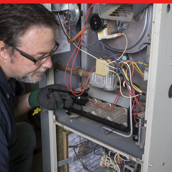 Tech fixing an HVAC system