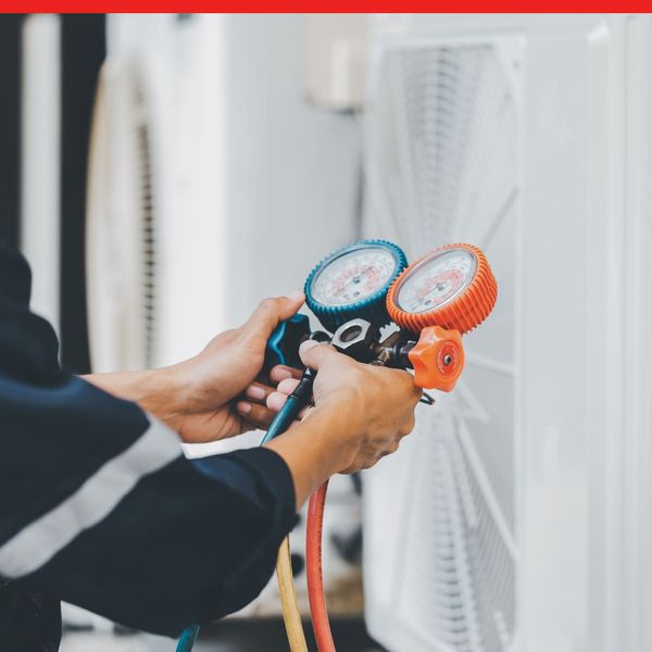 HVAC service technician using gauges 