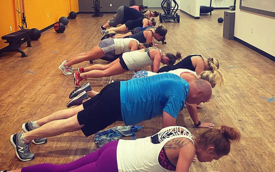 Group holding a plank