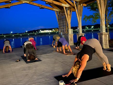 A gym class doing downward dog.