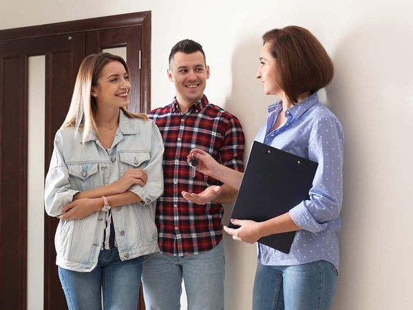 A couple at a showing with their real estate agent