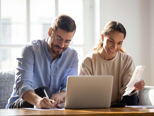 A couple working on their budget with a laptop