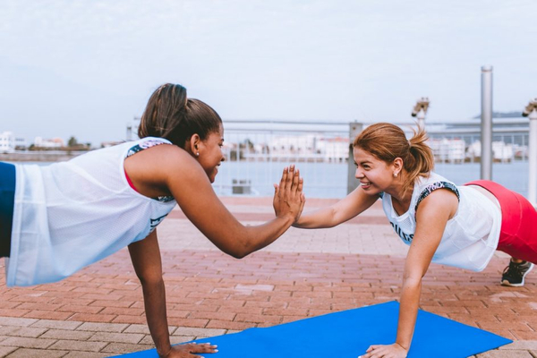 Two women exercising and smiling