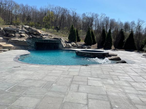 pool with big waterfall and spa hot tub