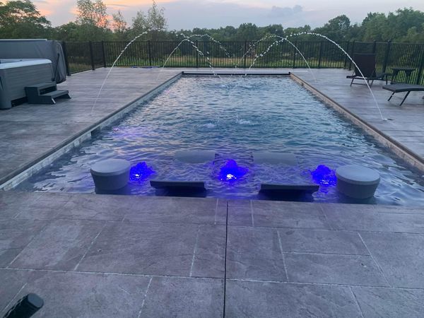 pool with water fountains and chairs