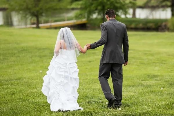 a bride and groom outside by the lake