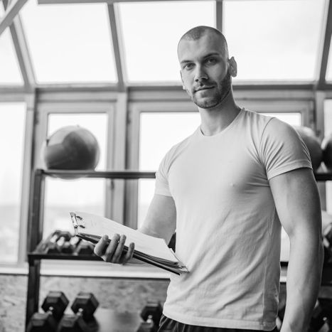 1 - personal trainer with clipboard in front of weight rack.jpg