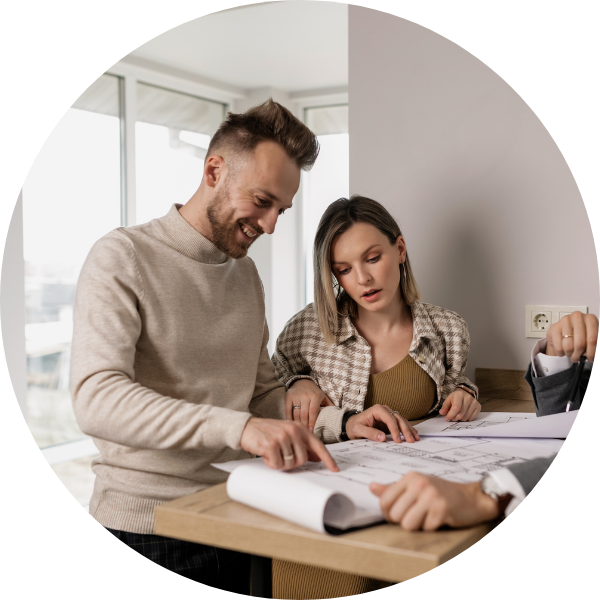 Two homebuyers looking at floorplans. Two homebuyers looking at floorplans.