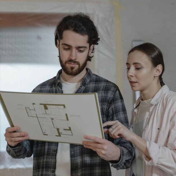 couple looking at plans for home addition