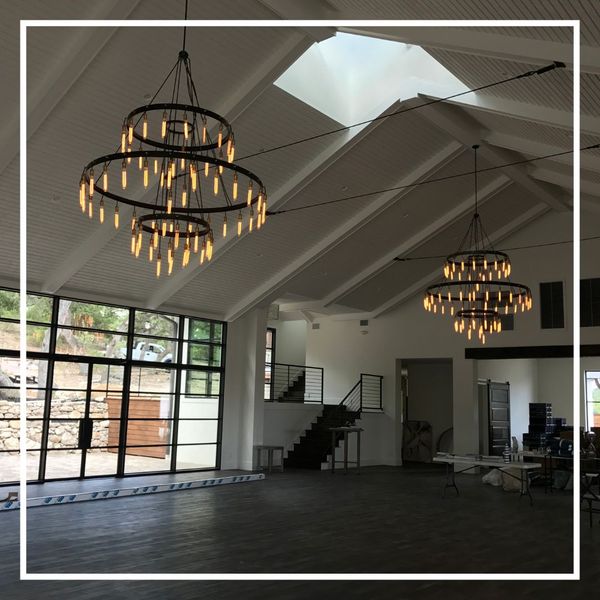 chandeliers in high vaulted ceiling in barndominium