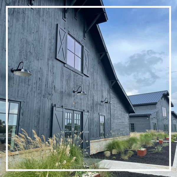 imposing gray barndominium against sky