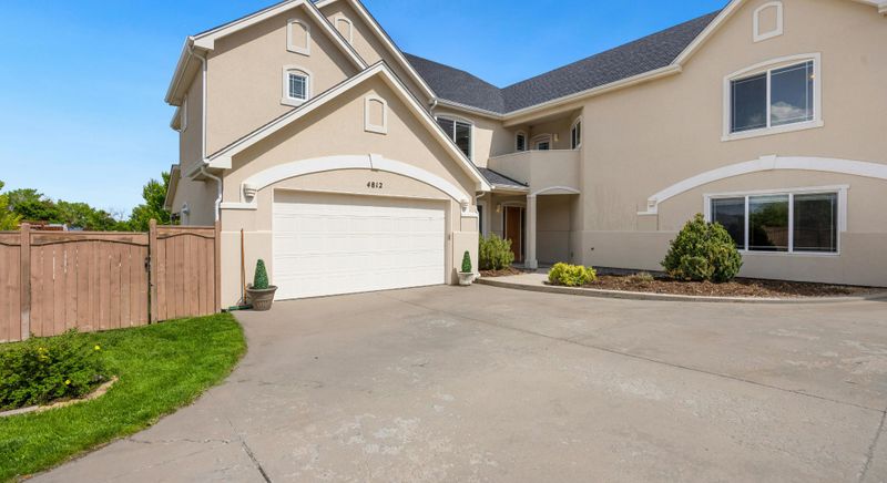The driveway, entry, and garage door of a suburban home