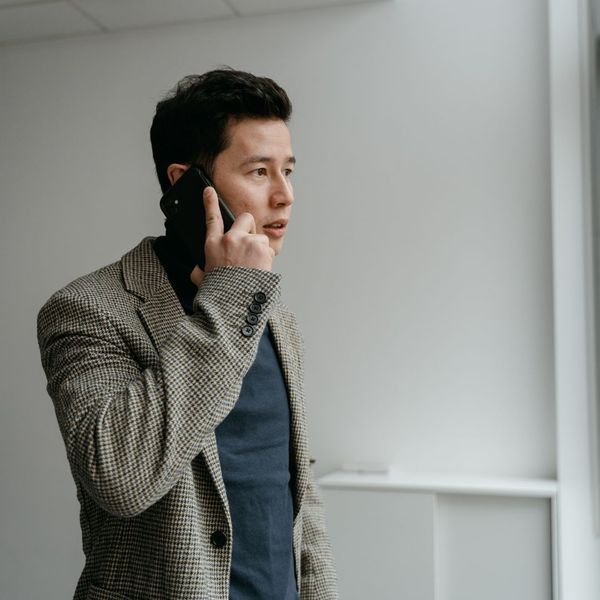 A man speaking on the phone to call a garage door service