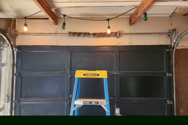 ladder in garage, hanging lights