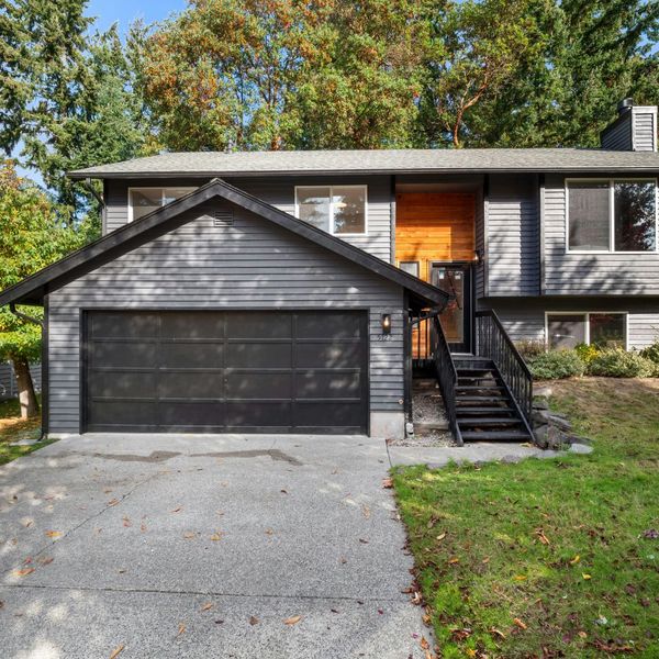 A modern home with a nice black garage door