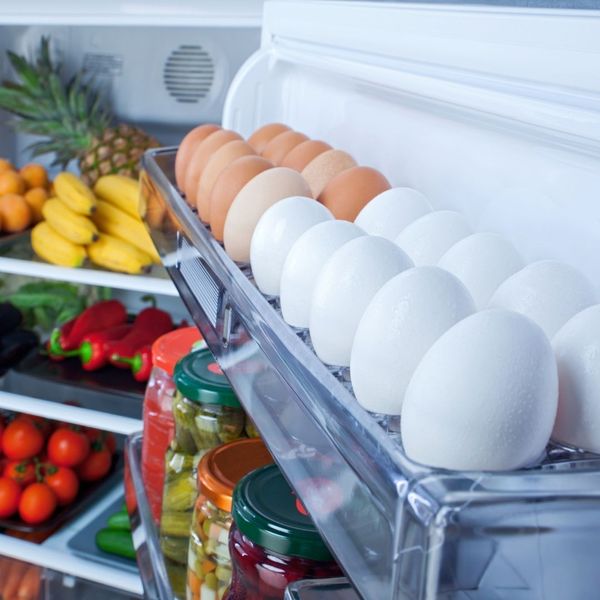 eggs and produce in open refrigerator