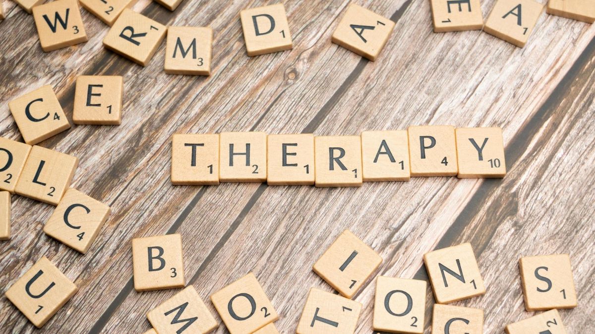 Scrabble pieces that spell out "THERAPY"