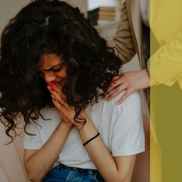 A therapist comforting a distraught young client