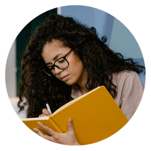 A therapist taking notes in a large yellow notebook