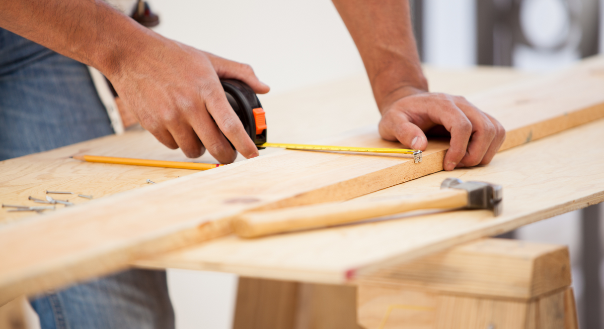 contractor measuring wood 