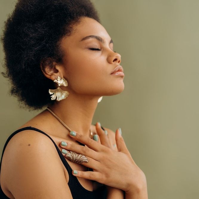 a woman with her hands held over her chest
