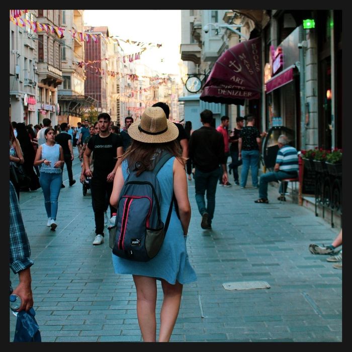 people walking by buildings