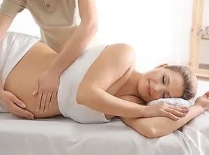 a pregnant woman receiving a prenatal massage