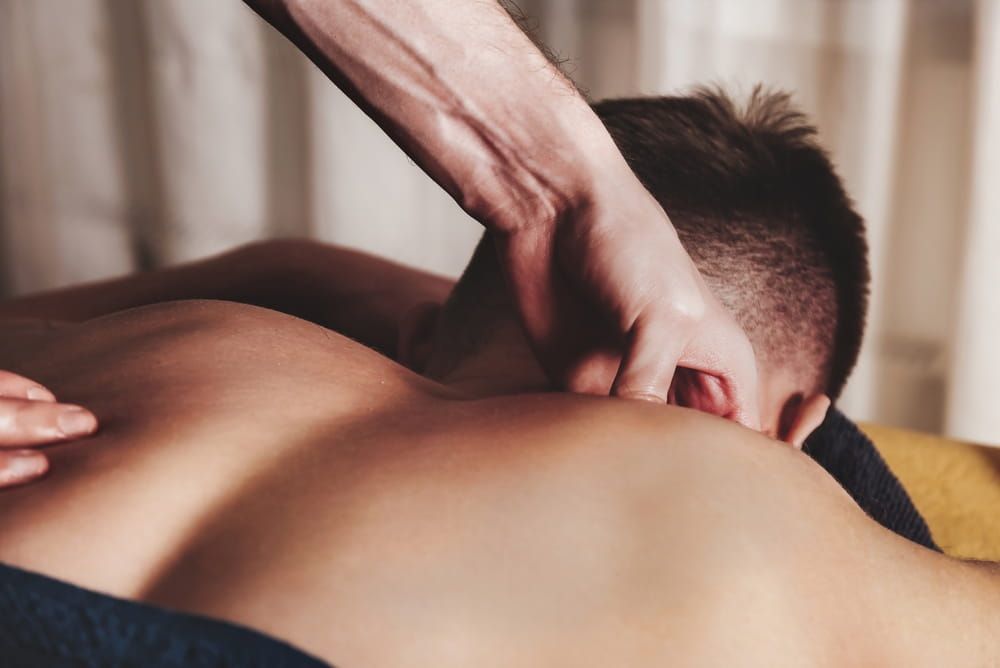 A man getting a relaxing neck pain relief massage 