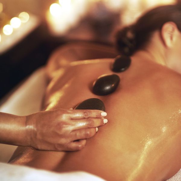 closeup of a woman receiving a thai hot stone massage 