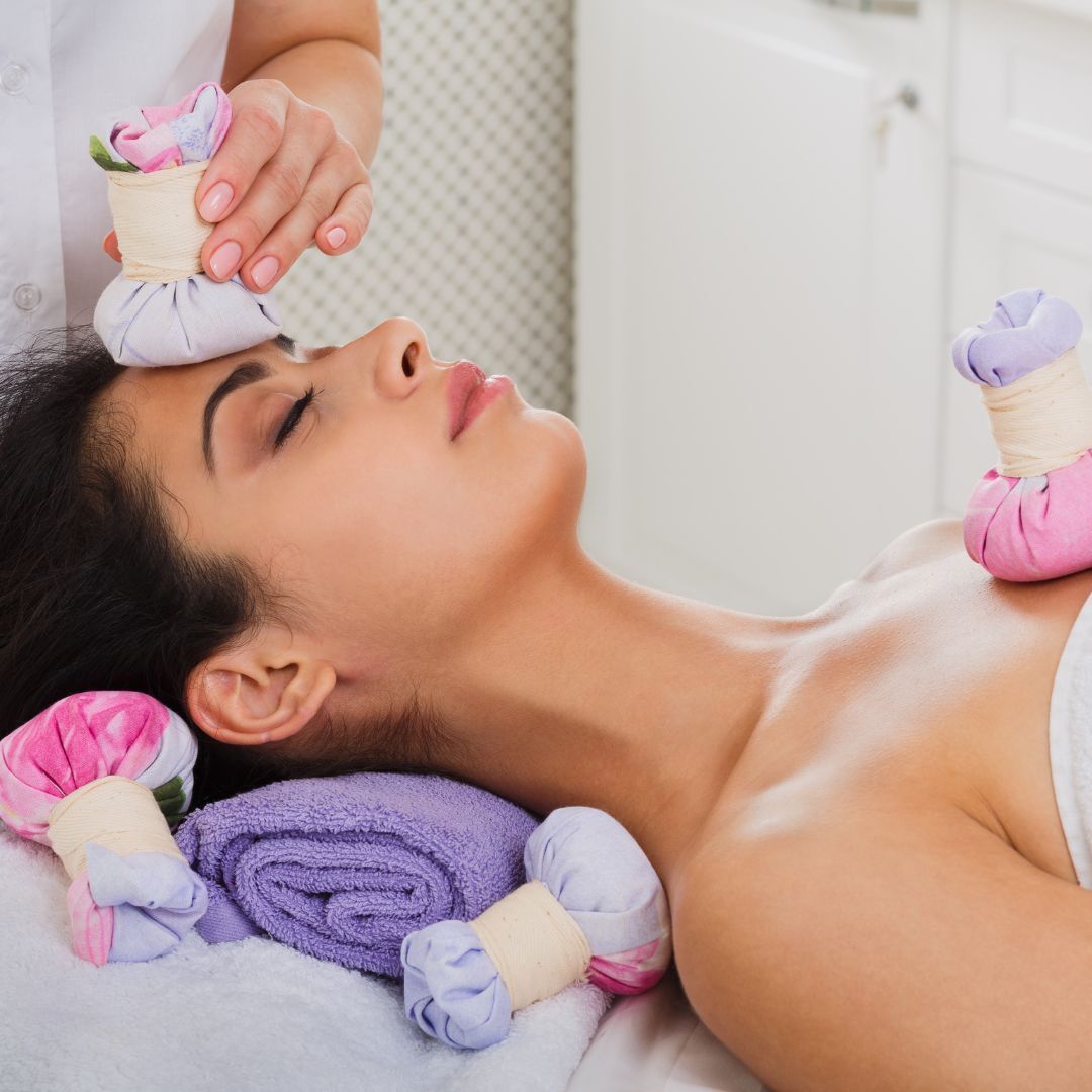 closeup of a woman receiving a thai herbal ball massage 