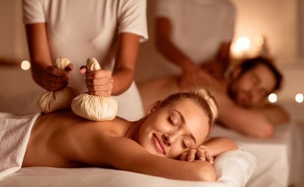 A woman relaxes with a Thai Herbal Ball body treatment