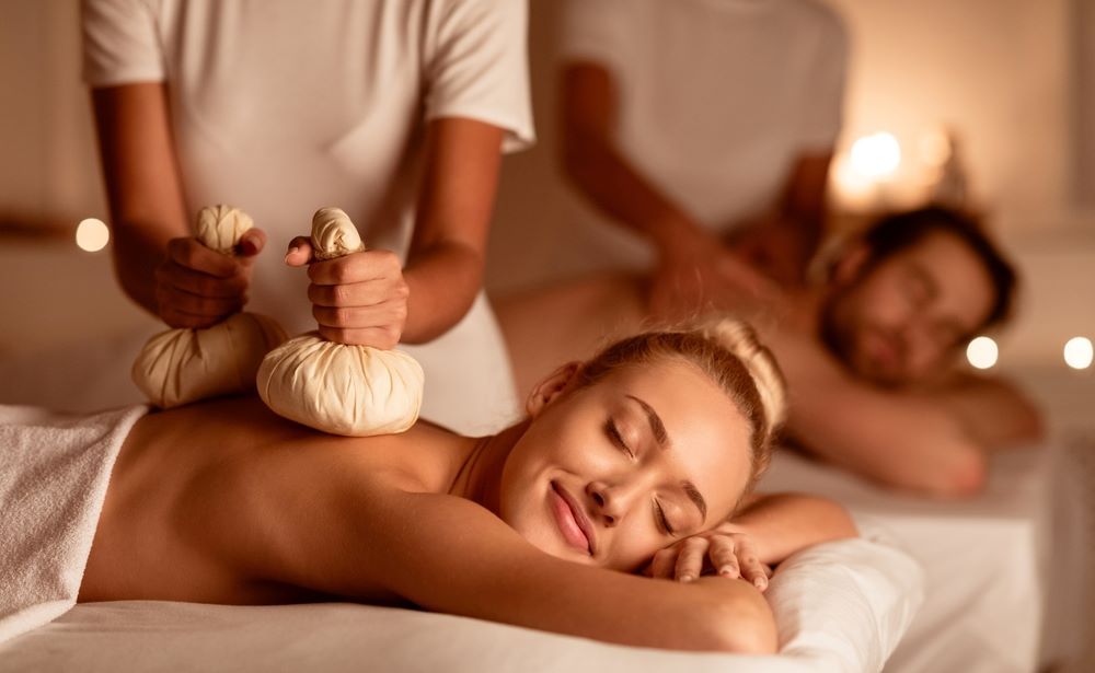 A woman relaxes with a Thai Herbal Ball body treatment