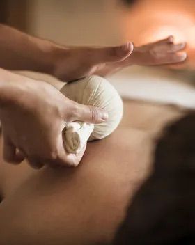 closeup of a woman receiving an herbal thai ball massage