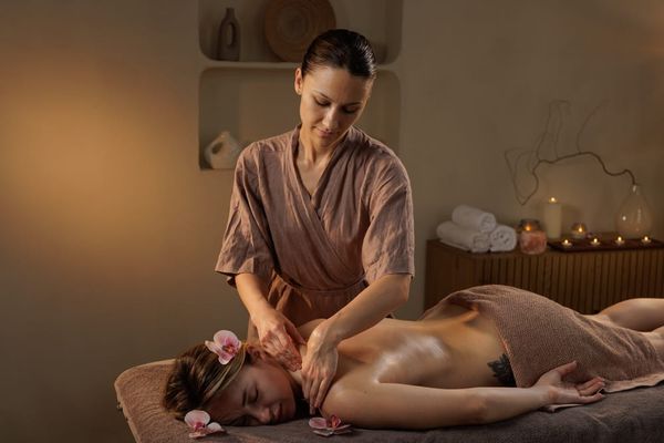 A therapist with therapeutic massage certification providing a relaxing full-body massage