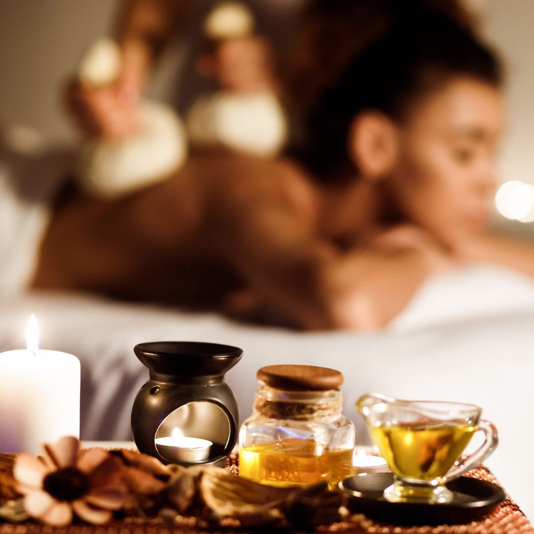 blurred-focus image of a woman receiving a thai herbal ball massage with oils in-focus up close
