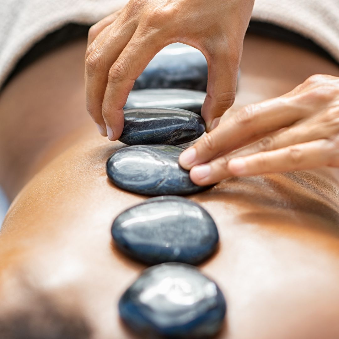 closeup of a woman receiving a thai hot stone massage 