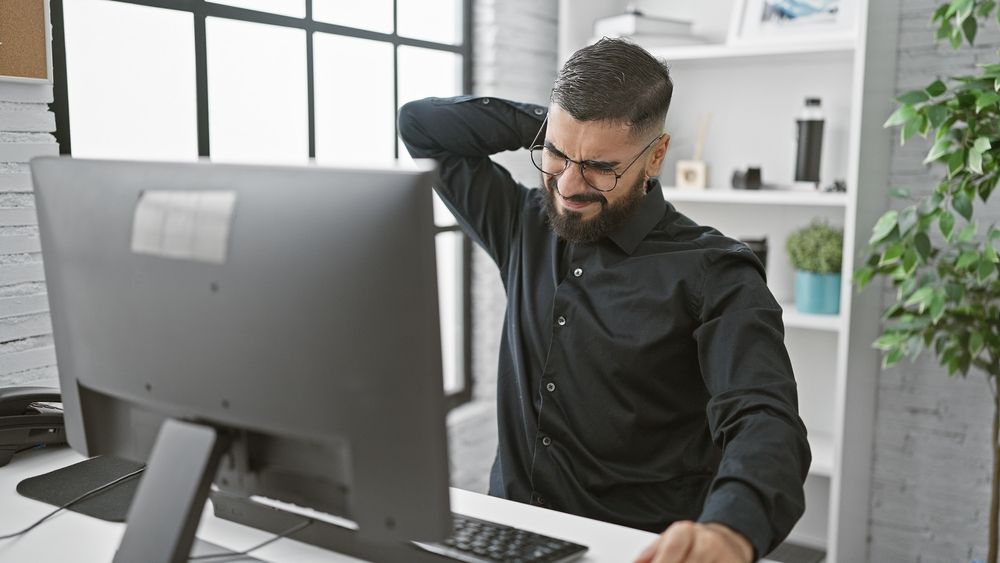 A man experiences the painful effects of office syndrome