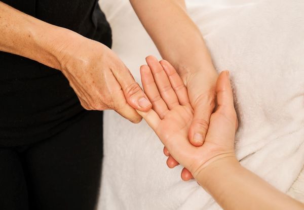 A woman enjoys a hand massage