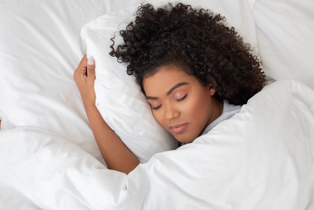 A woman sleeping peacefully after following her night routine list