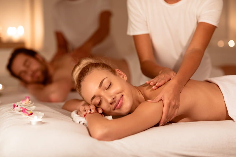 Couple enjoying a relaxing side-by-side spa massage, a calming indoor date activity
