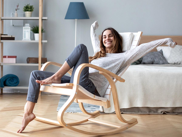 Happy relaxed woman sitting in a chair