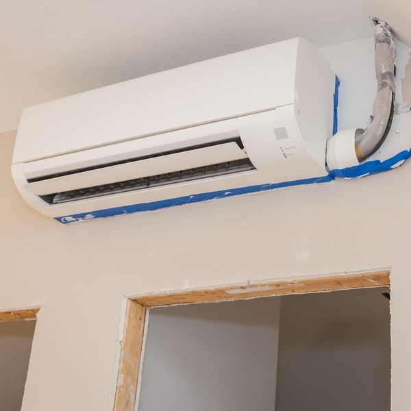 White ductless AC unit above a door