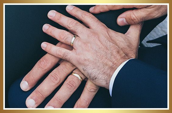 photo of a same sex couple and their wedding rings